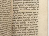 an old book opened to reveal a page of text on a white surface