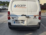 a white van that is parked on the side of the road