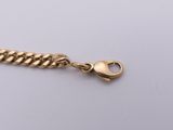 a gold chain with a clasp on a white background