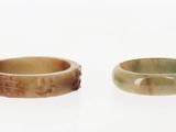 paire d'anneaux en bois sculpté sur une surface blanche, sur fond blanc