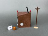 a small book with a pen and a lamp post next to it