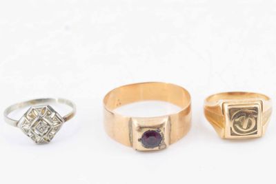 three different rings are shown on a white surface