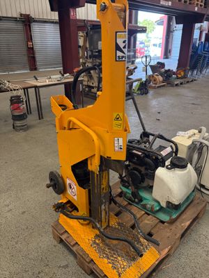 a yellow machine sitting on top of a pallet in a warehouse