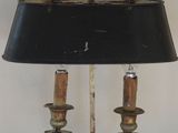 a lamp that is sitting on a table with a black shade