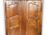 an image of a wooden armoire with two doors on each side