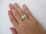 a woman ' s hand with a diamond ring on it