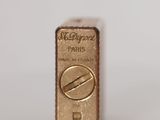 a close up of a gold bar on a white surface