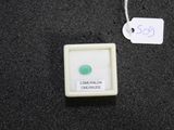a small white box with a green stone in it