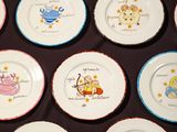 many plates with different designs on them on a table