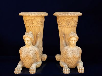 pair of antique greek statues of a woman and a child