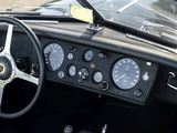 a steering wheel and dashboard of a vintage car