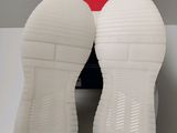 a pair of white shoes sitting on top of a box