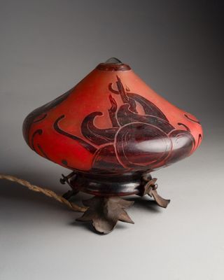 an image of a red and black vase on a stand