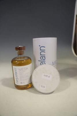 a bottle of liquid and a container of liquid on a table