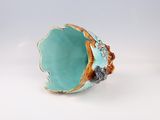 an image of a turquoise and gold ring on a white surface