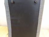 a black and gray bag sitting on a wooden floor