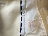 a close up of a white jacket with a monogram on it