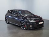 volkswagen golf gtr with black paint and red rims parked in a room