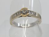 a close up of a ring with a diamond on top of it