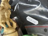 a cupcake in a plastic bag with a figurine on top of it