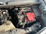 a car engine with a red battery in it