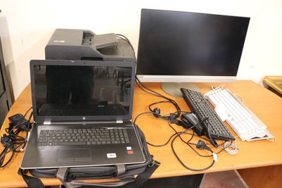 a laptop computer sitting on top of a desk next to a computer monitor