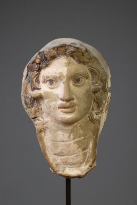 head of a woman with curly hair on a stand