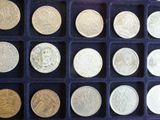 a lot of different coins in a blue box