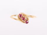 an image of a gold ring with a ruby stone in the middle