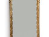 an image of a gold framed mirror on a white wall
