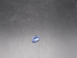a blue stone sitting on top of a metal table