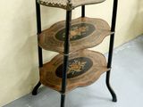 a three tiered table with decorative designs on it