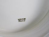 a white plate with a brown inscription on it