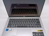 a silver laptop computer sitting on top of a white table