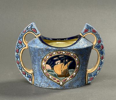 a blue vase with a picture of a cat on it
