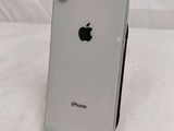 an apple iphone sitting on top of a black stand on a white surface