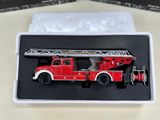 a red fire truck in a box on a table