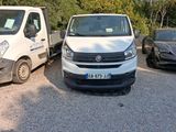 a white van and a black car parked in a parking lot