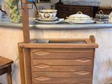 a wooden cabinet sitting in the middle of a kitchen