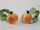 two salt and pepper shakers with apples on them