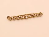 a gold and diamond bar brooch