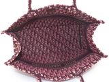 the small purple bag is sitting on a white surface