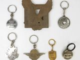 many different key chains that are on a white surface