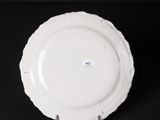 a white plate sitting on top of a black table