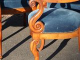 two blue chairs sitting next to each other on the street