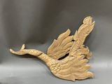 a close up of a wooden sculpture of a bird on a gray background