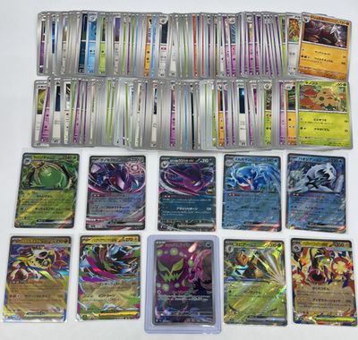 a bunch of pokemon cards sitting on top of a table