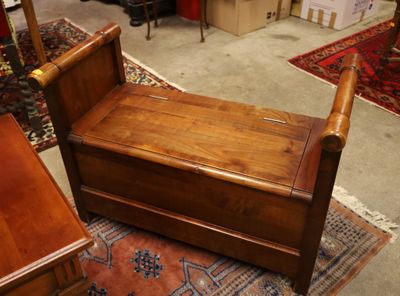 a wooden bench sitting on a rug in a room