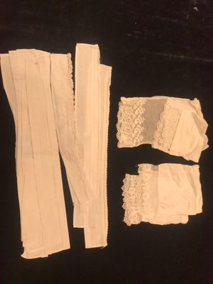 white lace garters and garters laid out on a black surface