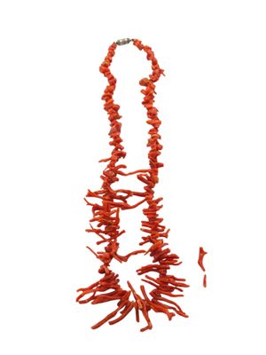 red coral necklace and earrings set on a white background